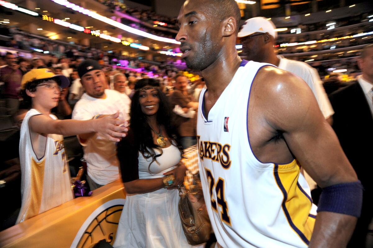 Lakers guard Kobe Bryant walks by his mother, Pam, following his team's victory over the Utah Jazz in 2010.