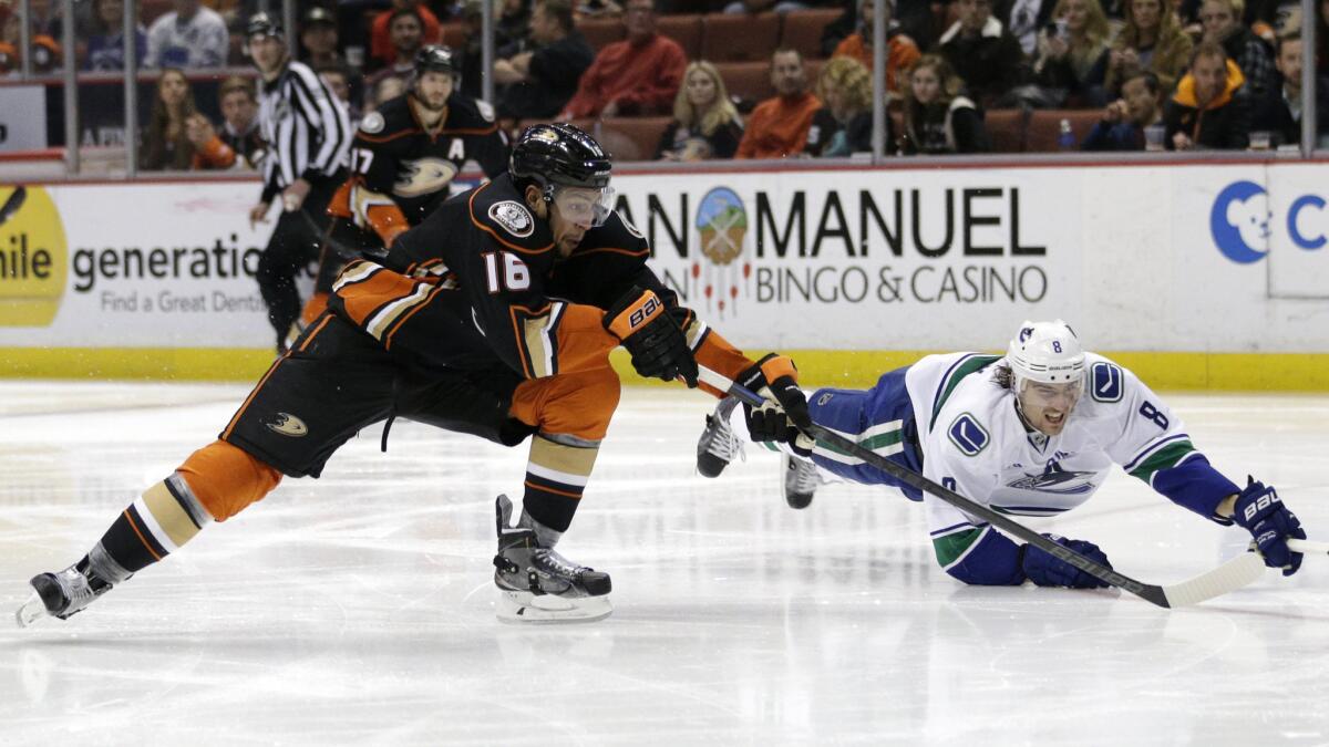 Ducks forward Emerson Etem, left, and Vancouver Canucks defenseman Chris Tanev chase after the puck during a game on Dec. 28.