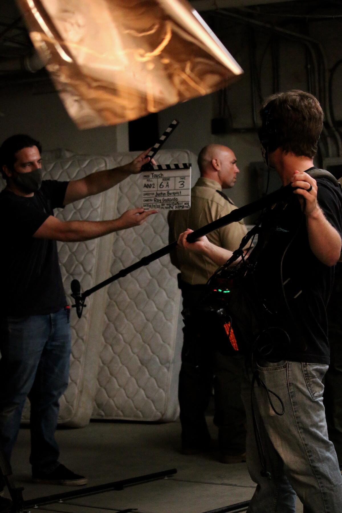 Martin McCarthy, supporting actor Jayce Venditti and visual effects artist John Menvielle work on the set of "Touch."
