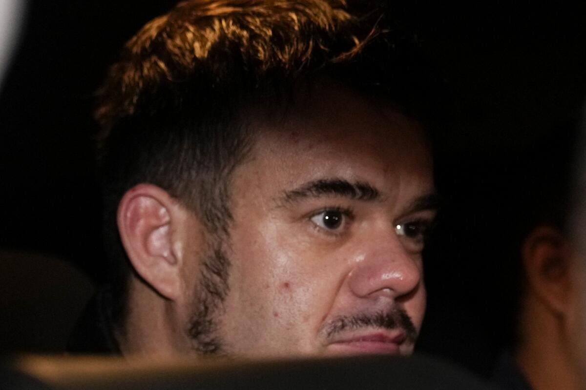 A closeup of a man's face surrounded by darkness