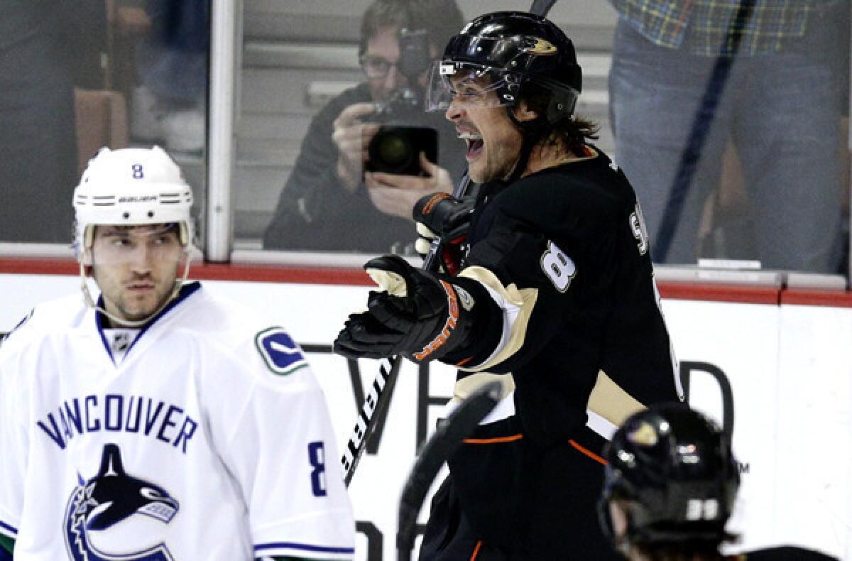 Ducks winger Teemu Selanne celebrates after scoring against Chris Tanev and the Canucks during a game at the Honda Center in Anaheim earlier this season.