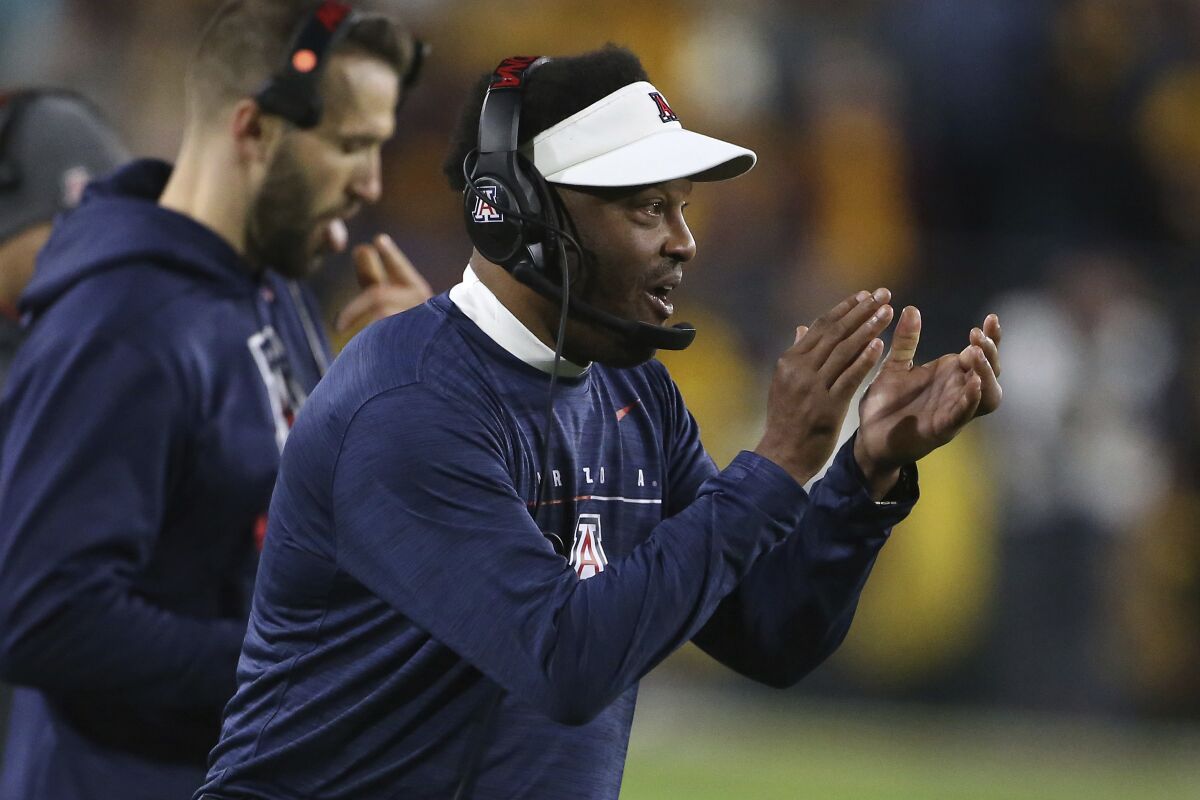 Arizona coach Kevin Sumlin claps on the sideline.