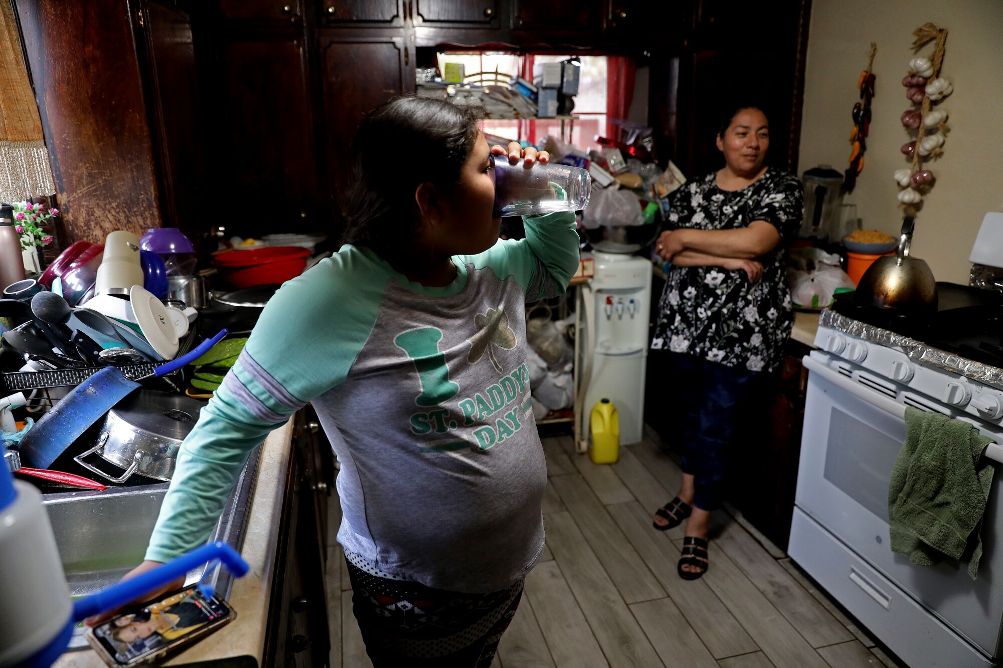 Natalia Ledesma, 9, drinks water from a five-gallon jug at her home in Fresno County.