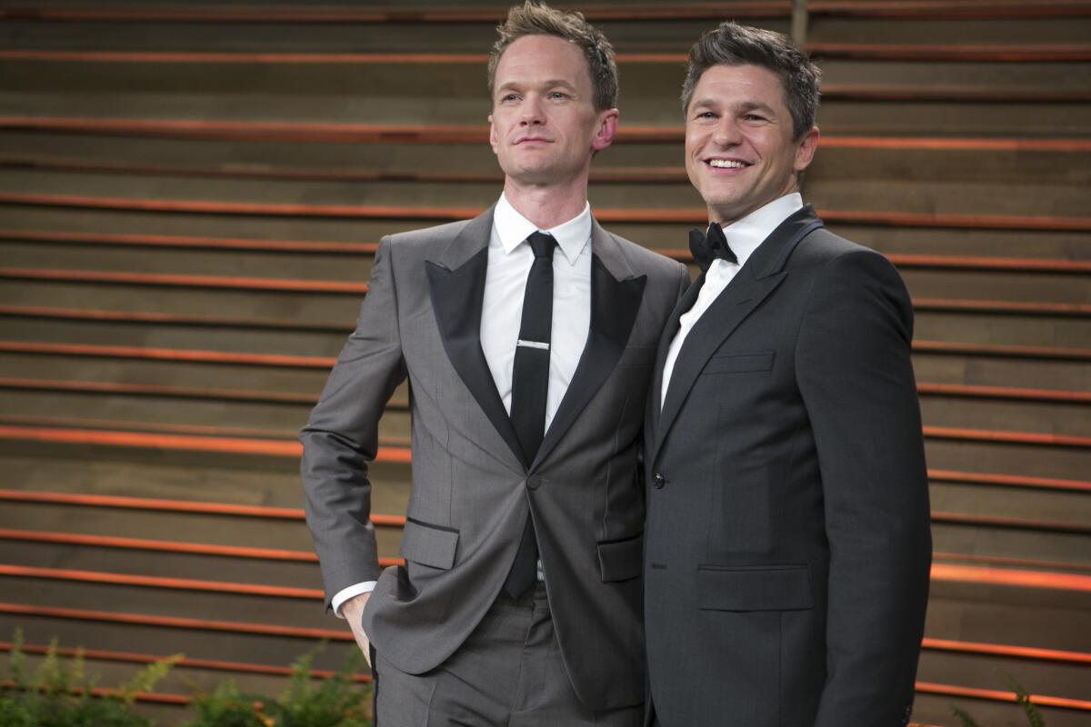 Neil Patrick Harris says it was his character, not the actor himself, who cursed at an audience member during a performance of "Hedwig and the Angry Inch." Above, Harris and his husband, David Burtka, arriving at the Vanity Fair Oscar party last month.