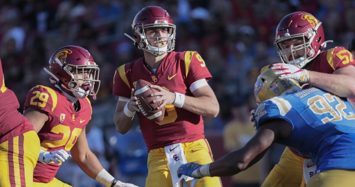 Trojans quarterback Kedon Slovis drops back to pass against the Bruins during their game on Nov. 23, 2019, at the Coliseum.