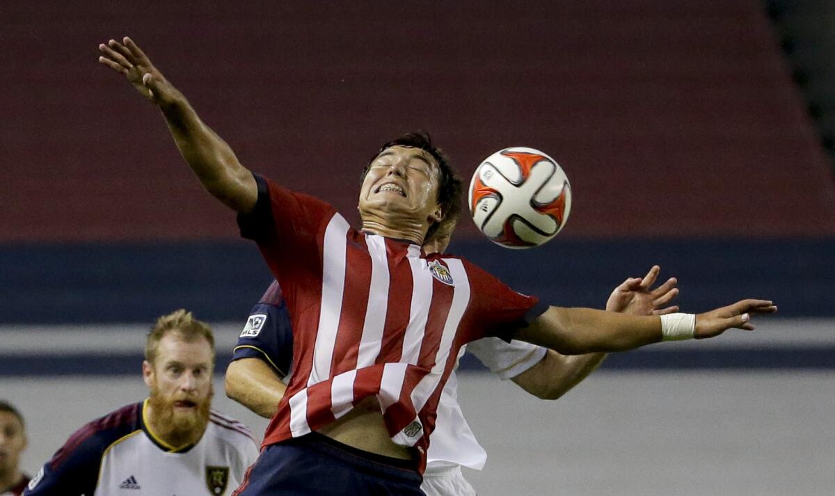 Chivas USA midfielder Erick Torres, front, heads the ball away during a game against Real Salt Lake in Carson on June 28.