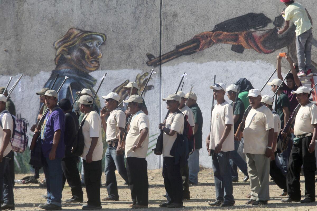 Armed residents take part in a march this month marking the first anniversary of a vigilante group in the Mexican city of Ayutla de los Libres. The southwestern state of Guerrero has seen a number of community "self-defense" groups spring up in response to violent criminal gangs.