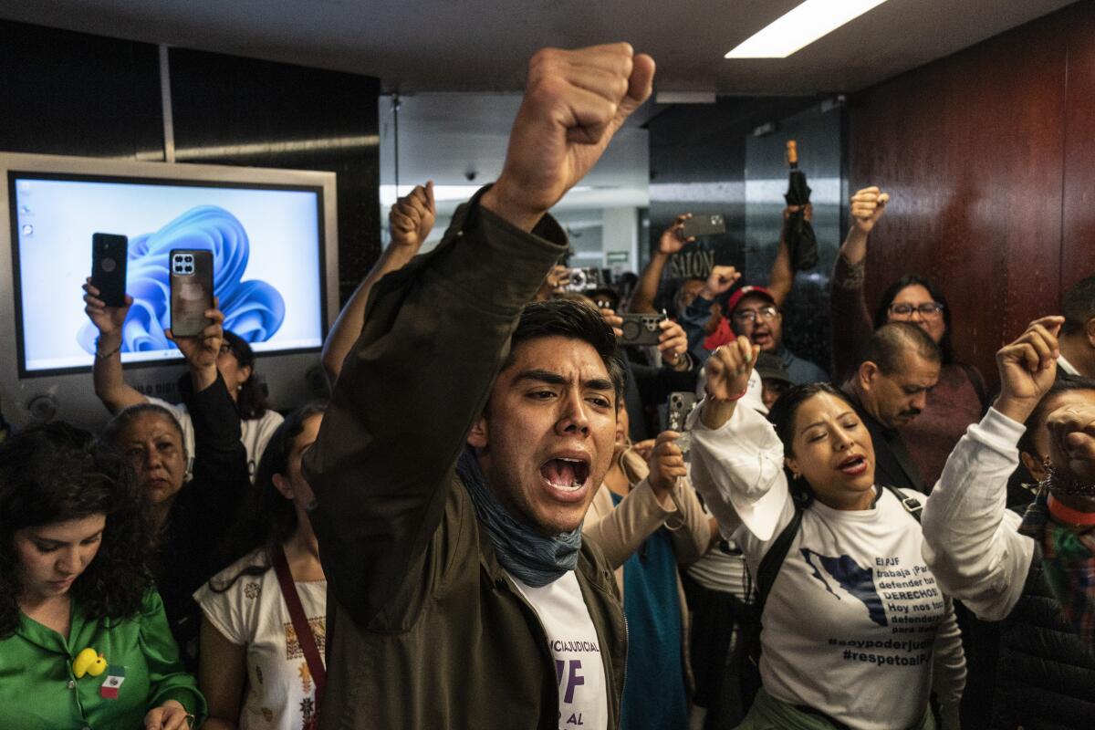 Protesters attempt to break into a room in the Senate in Mexico City.