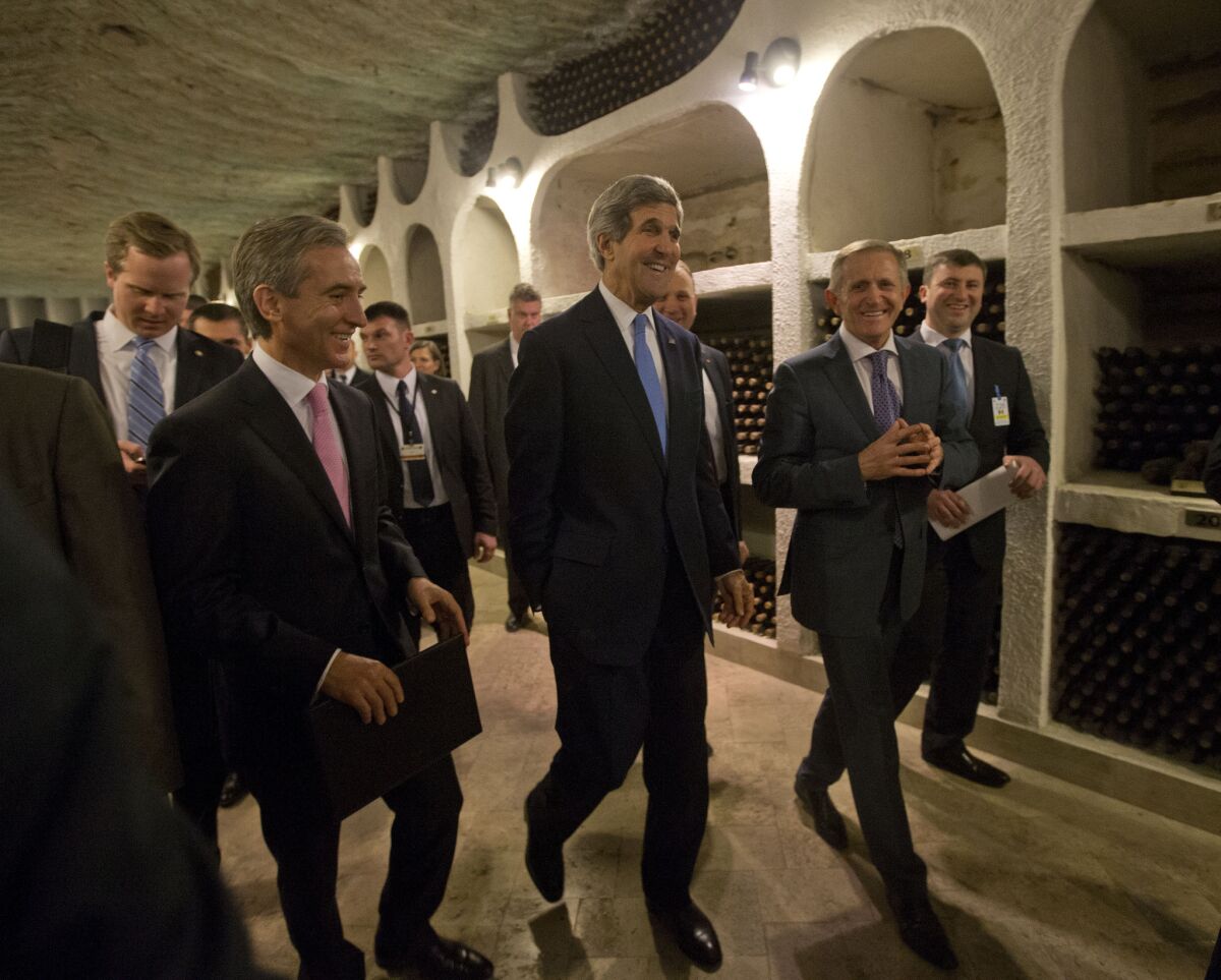 U.S. Secretary of State John Kerry, center, tours the Cricova Winery and cellars Wednesday with Moldovan Prime Minister Lurie Leanca, left. It was the first visit by America's top diplomat to Moldova, a former Soviet republic, in more than 20 years, spurring Russian media to call it part of a U.S. campaign for influence in Eastern Europe.