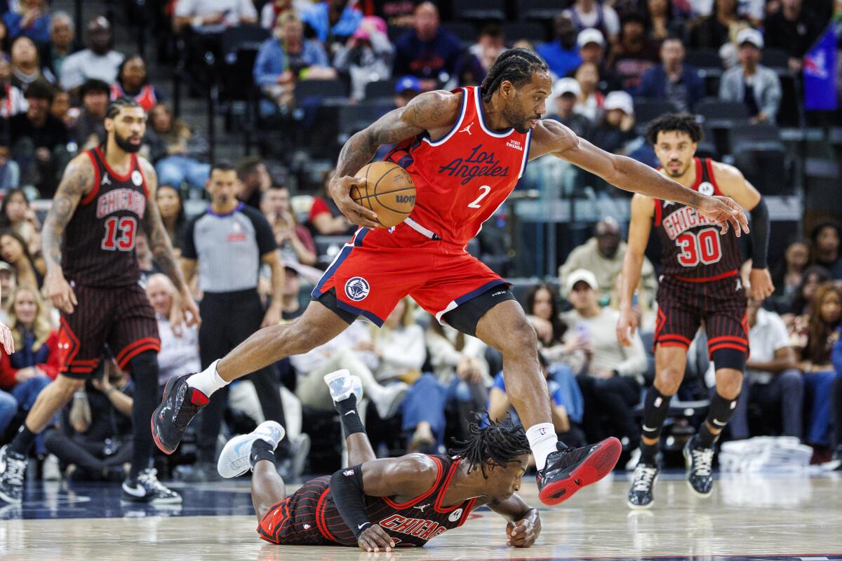Clippers star Kawhi Leonard leaps over Chicago Bulls forward Leonard Miller.