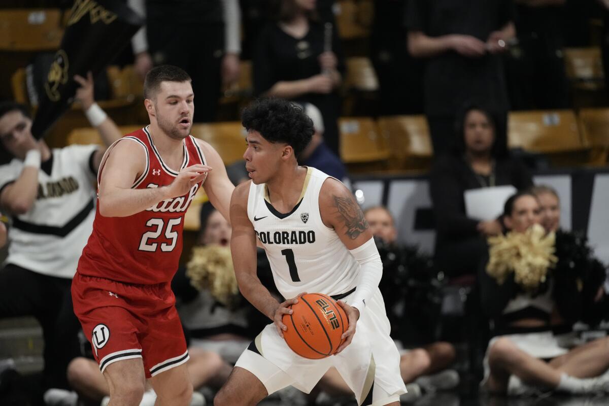 Colorado guard Julian Hammond III and Utah guard Rollie Worster in the first half on March 4, in Boulder, Colo.