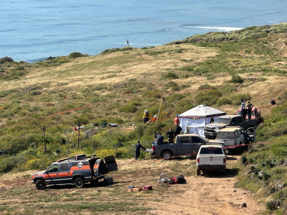 Mexican officials work to recover four bodies found at the bottom of a well in the Santo Tomas area south of Ensenada 