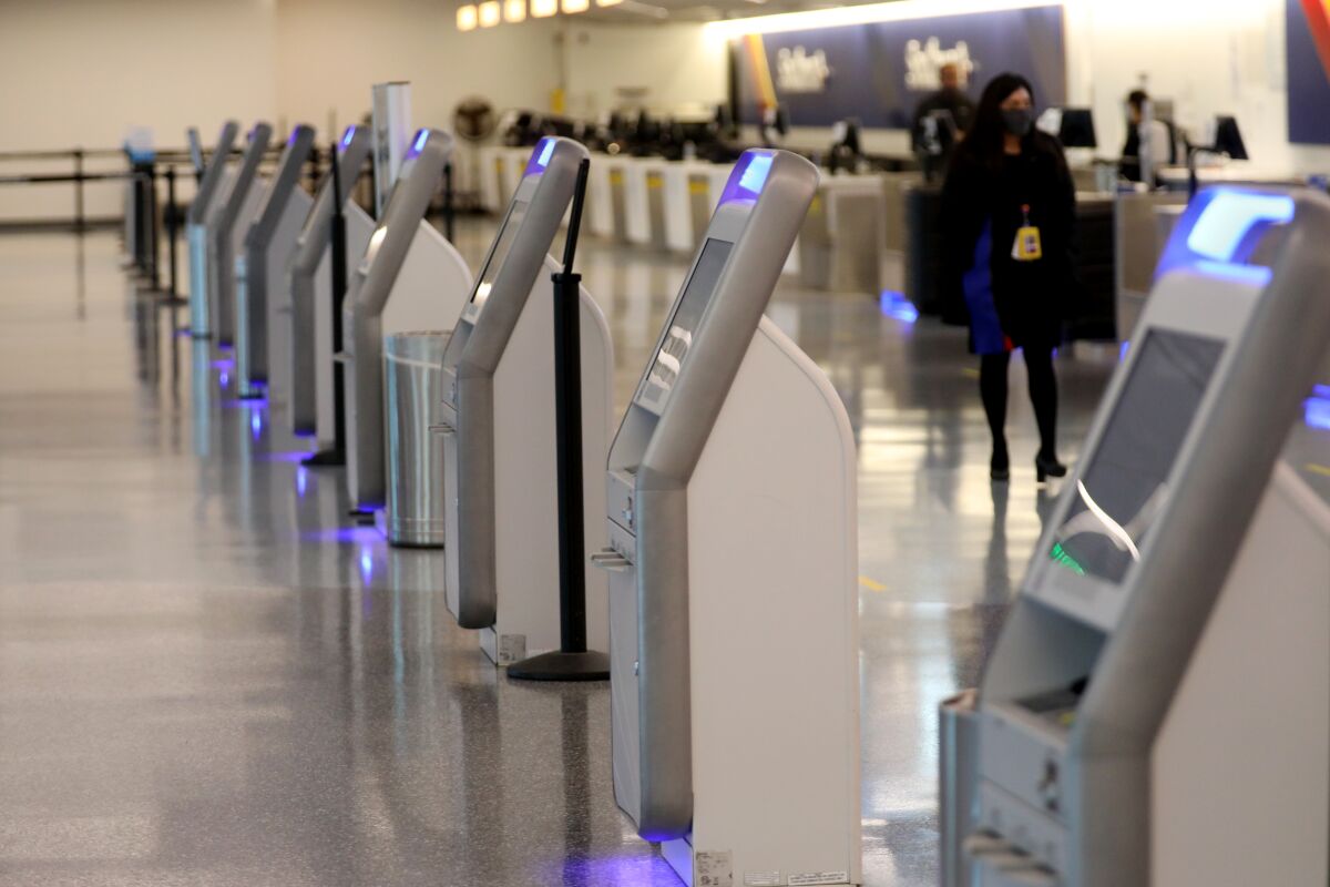 A row of airport ticketing kiosks 
