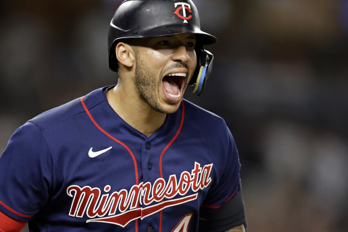 Minnesota Twins' Carlos Correa reacts after hitting a two-run home run during the eighth inning against the New York Yankees in a baseball game Thursday, Sept. 8, 2022, in New York. (AP Photo/Adam Hunger)