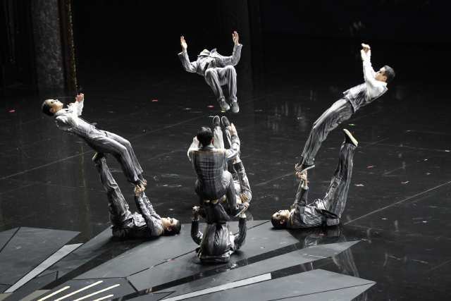 Acrobats flip during a movie-themed performance by Cirque du Soleil in the midst of the 84th Academy Awards show.