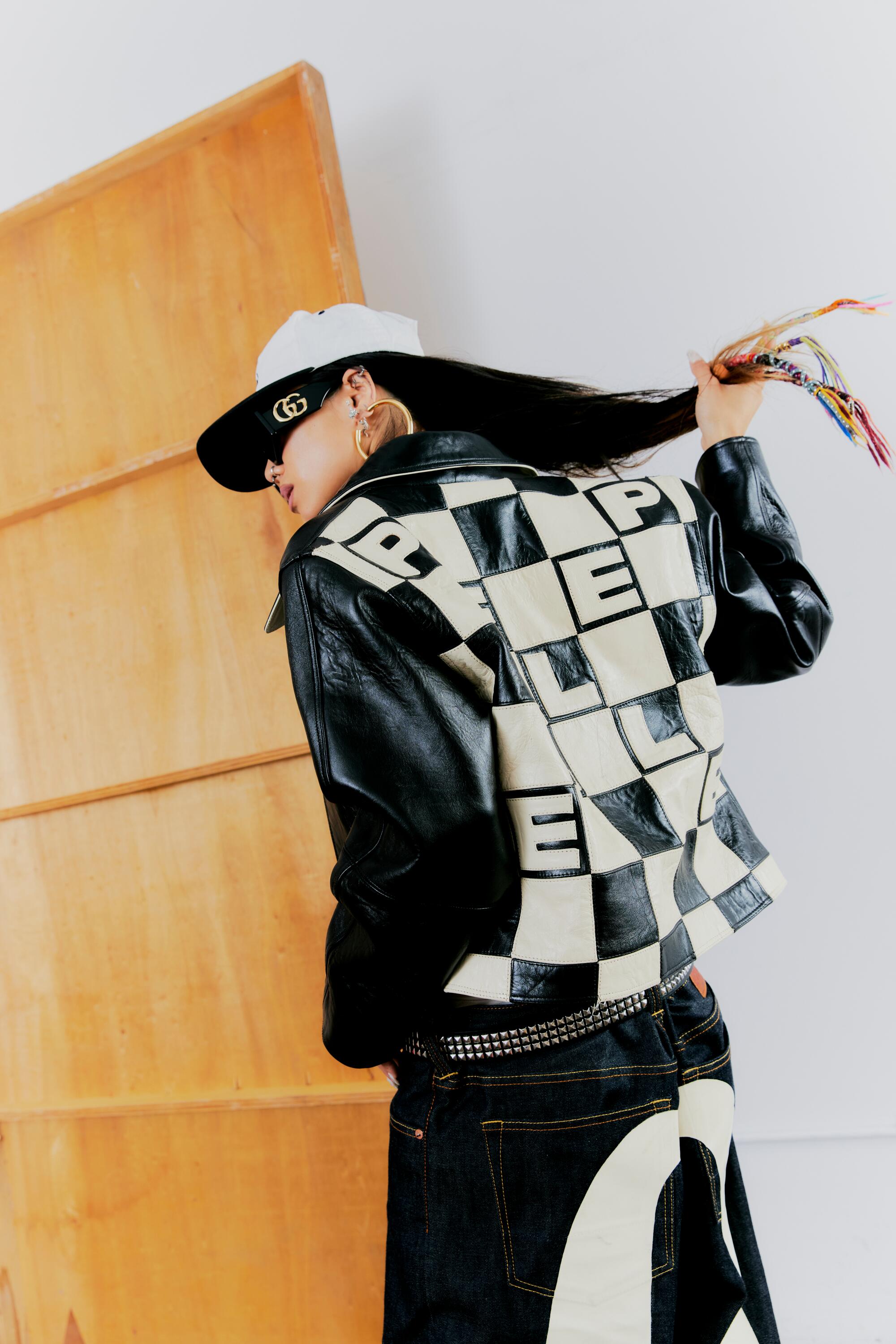Ann-Marie Hoang showing the back of her jacket with a black-and-off-white checkerboard pattern.