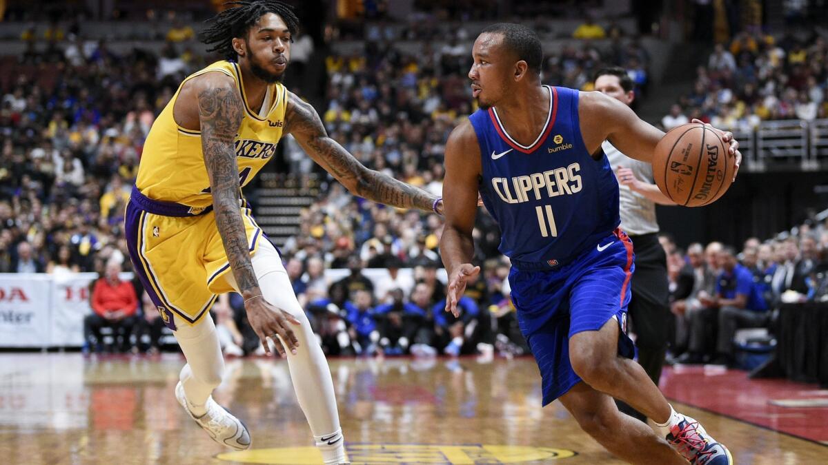 Clippers guard Avery Bradley tries to dribble past Lakers forward Brandon Ingram during Saturday's preseason game in Anaheim. The Clippers won 103-87.
