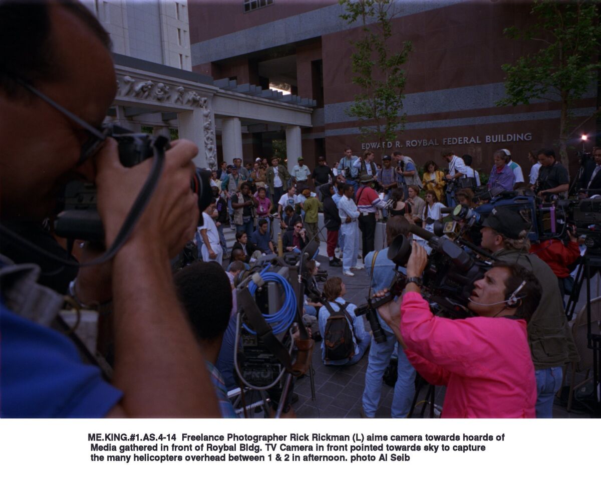 Media and members of the public gather in front of the Roybal Federal Building, where four police officers were being tried in the beating of Rodney King in 1993.