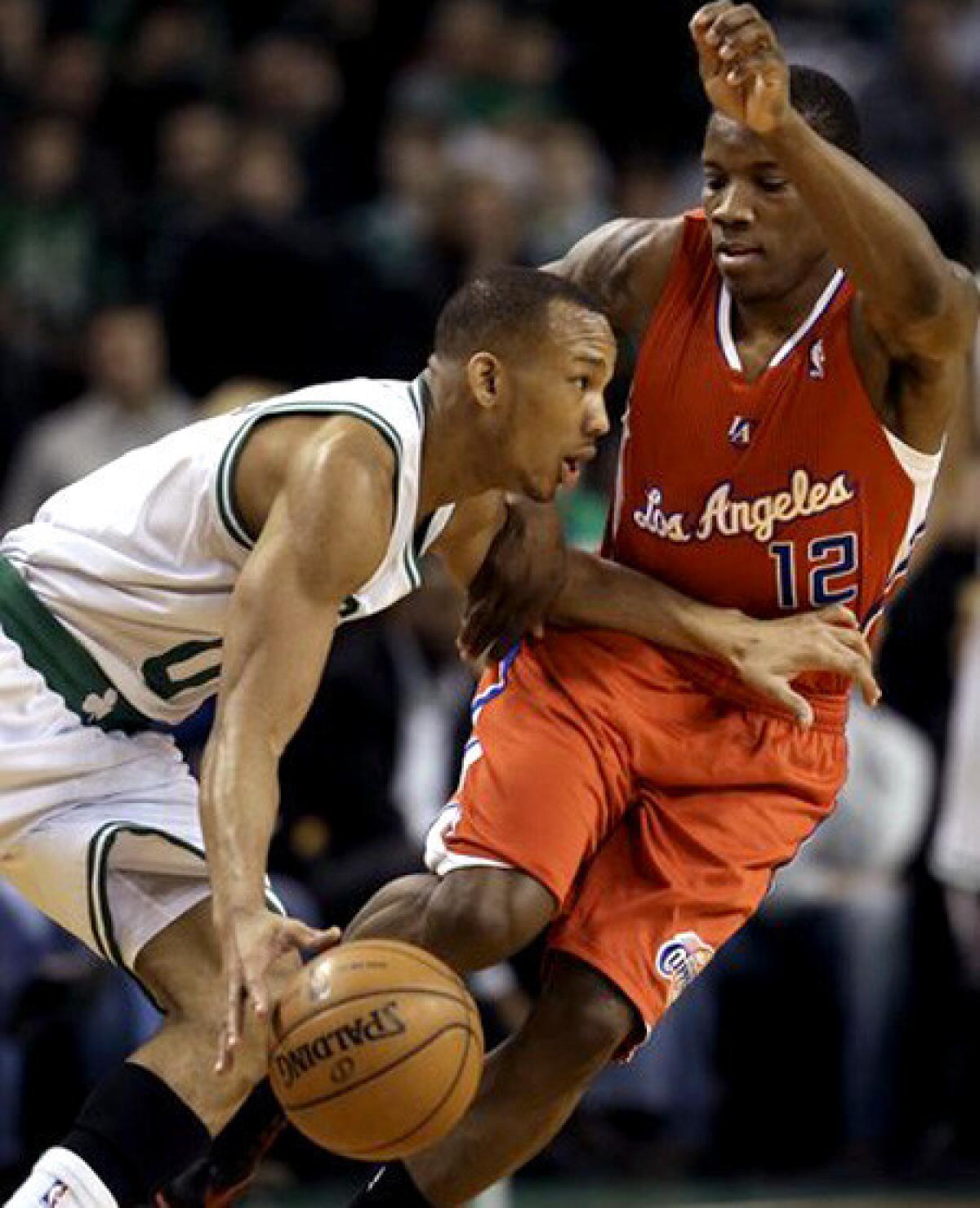 Clipper guard Eric Bledsoe tries to cut off a drive by Celtics guard Avery Bradley in the first quarter Sunday.