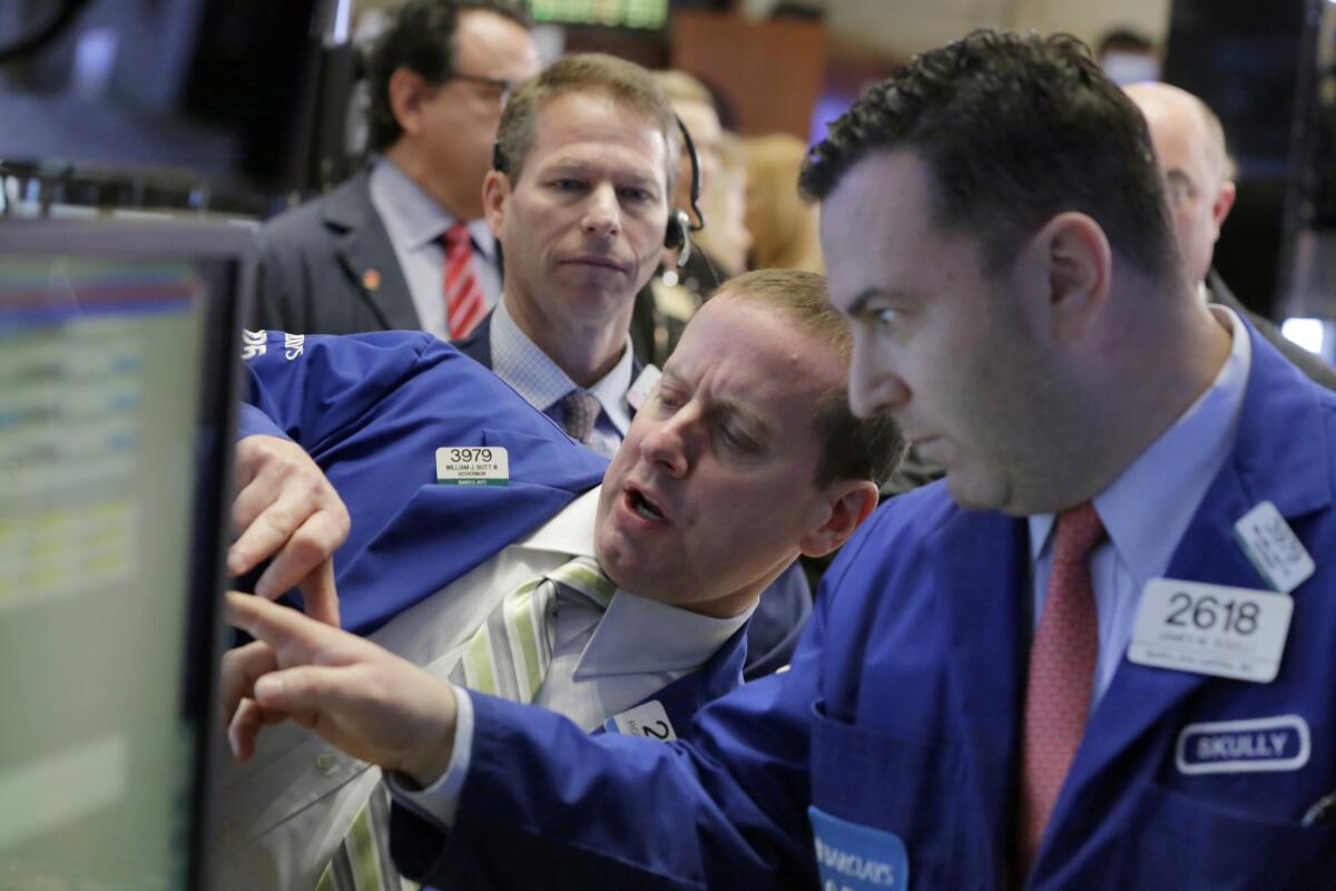 Specialists work on the floor of the New York Stock Exchange on Tuesday.