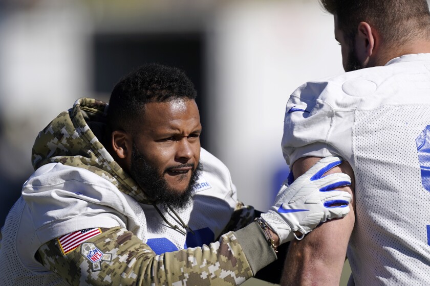 Los Angeles Rams defensive end Aaron Donald, left, works out with nose tackle Greg Gaines during an NFL football practice Friday, Jan. 28, 2022, in Thousand Oaks, Calif., ahead of their NFC championship game against the San Francisco 49ers on Sunday. (AP Photo/Mark J. Terrill)