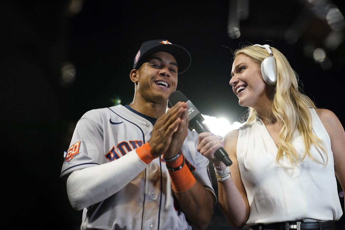 Houston Astros' Jeremy Pena, left, takes part in an interview after the team's 13-6 win over the Los Angeles Angels in a baseball game Friday, April 8, 2022, in Anaheim, Calif. (AP Photo/Marcio Jose Sanchez)