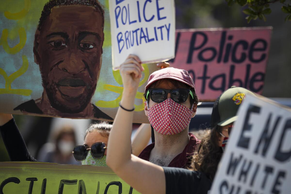 Person holding sign at protest against police brutality