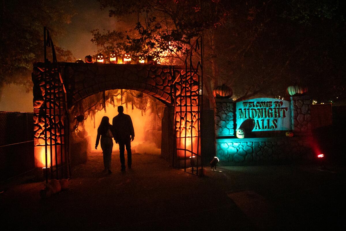 A couple enter Midnight Falls at the Haunted Hayride in Griffith Park.