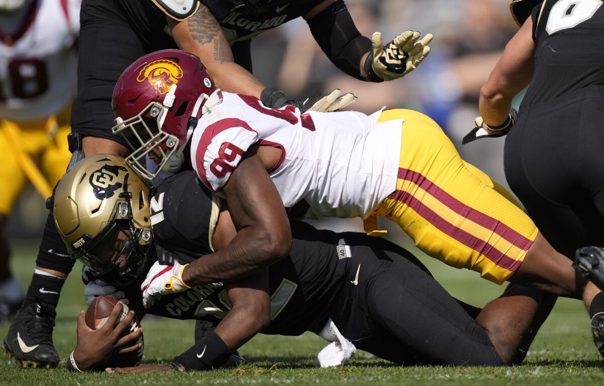 Southern California linebacker Drake Jackson, top, sacks Colorado quarterback Brendon Lewis