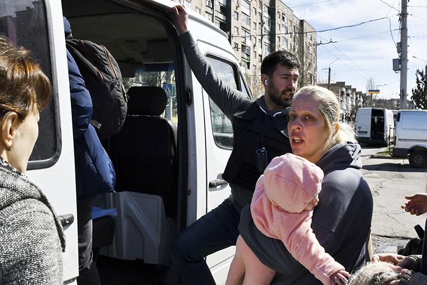 A woman boards a bus with her child during the evacuation of civilians in Kramatorsk, Ukraine, on Saturday.