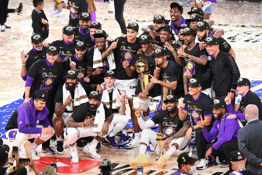 ORLANDO, FLORIDA OCTOBER 11, 2020-Laker players pose for a team photo after winning the NBA championship in Game 6 of the NBA FInals in Orlando Sunday. (Wally Skalij/Los Angeles Times)