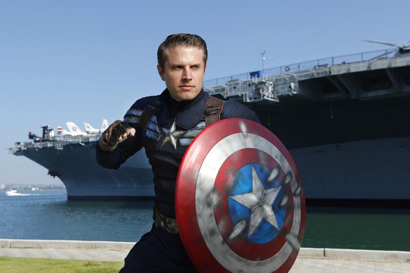 Matt Mullis dressed in Captain America's Stealth Suit, from The Winter Soldier near the USS Midway Museum in San Diego. Mullis has been to Comic-Con the last two year, and after ordering the suit made custom modifications with stars and stripes along with weathering it up. The first time he went to Comic-Con, his outfit was well received at a Marvel cosplay contest. and marvel did a cosplay contest.