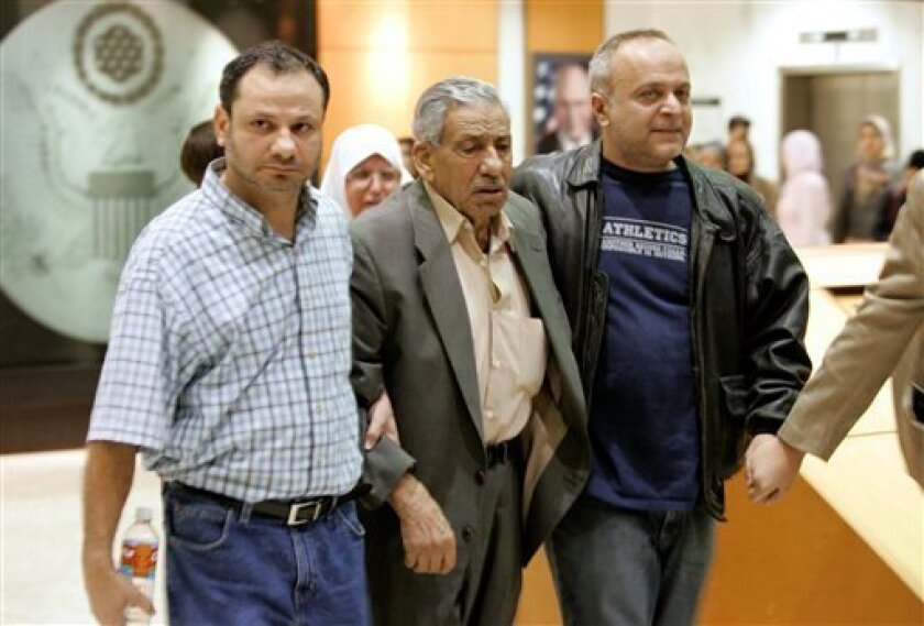 Friends and family members of five members of the Holy Land Foundation for Relief and Development walk out of the Earl Cabell Federal Court Building following the conviction of all five members, in Dallas, Monday, Nov. 24, 2008. A Muslim charity and five of its former leaders were convicted Monday of funneling millions of dollars to the Palestinian militant group Hamas in the retrial of the largest terrorism financing case since the attacks of Sept. 11. (AP Photo/Tony Gutierrez)