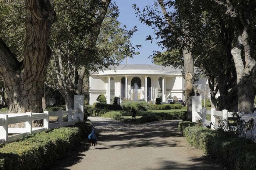Wayne Newton's former Las Vegas home, Casa de Shenandoah, is framed at the end of a tree-lined lane in this 2010 file photo.