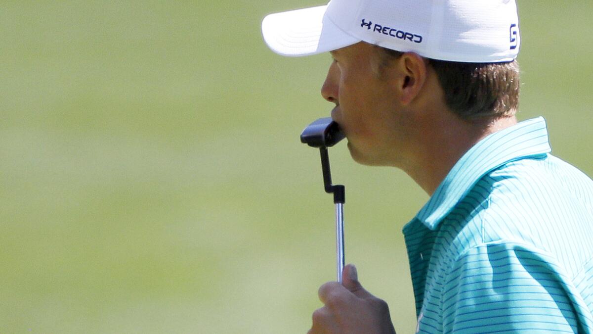 Jordan Spieth kisses his putter Thursday after saving par on the 16th hole during the first round of the Masters.