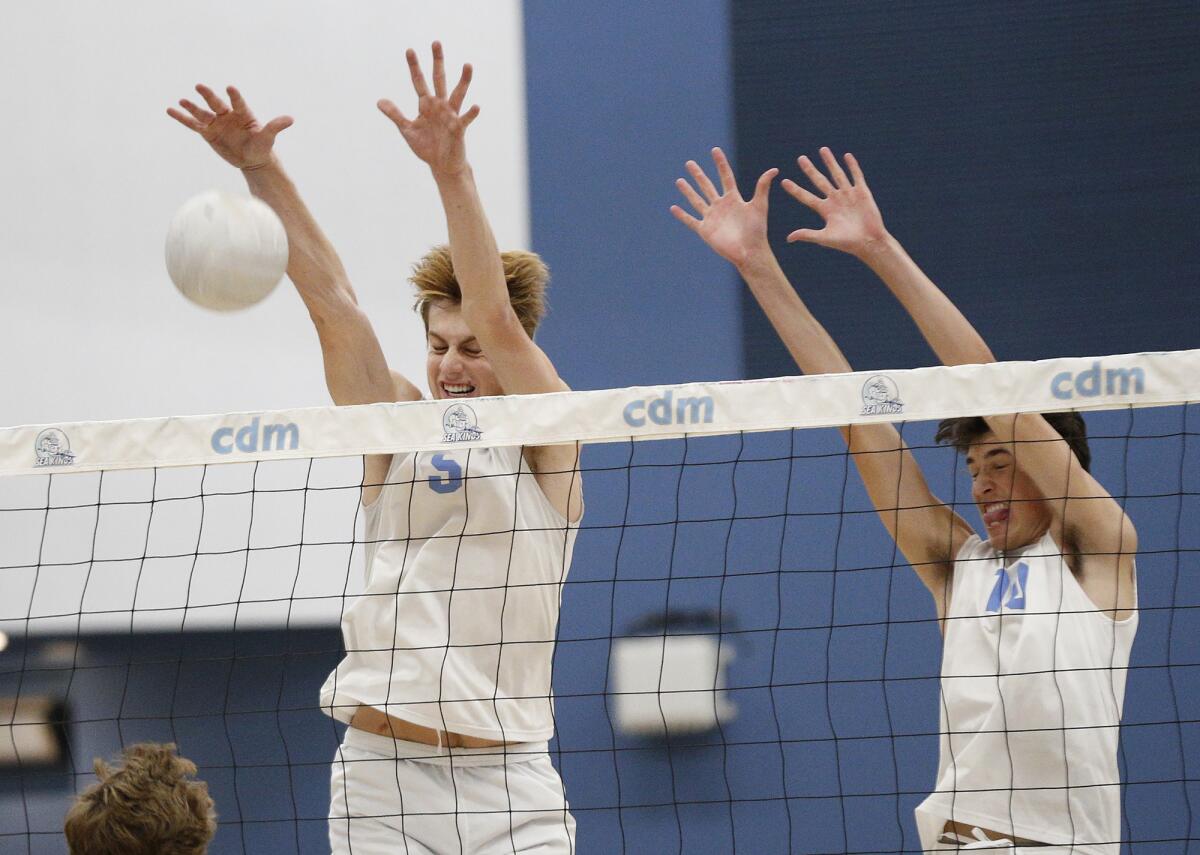 Corona del Mar's George Bruening (5) and Cade Alacano (10) combined for six total blocks against Loyola on Saturday.