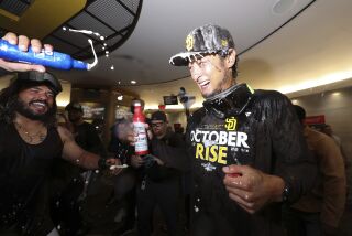 San Diego Padres' Yu Darvish, right, celebrates with Jorge Alfaro following a baseball game against the Chicago White Sox after clinching a wild-card playoff spot Sunday, Oct. 2, 2022, in San Diego. (AP Photo/Derrick Tuskan)