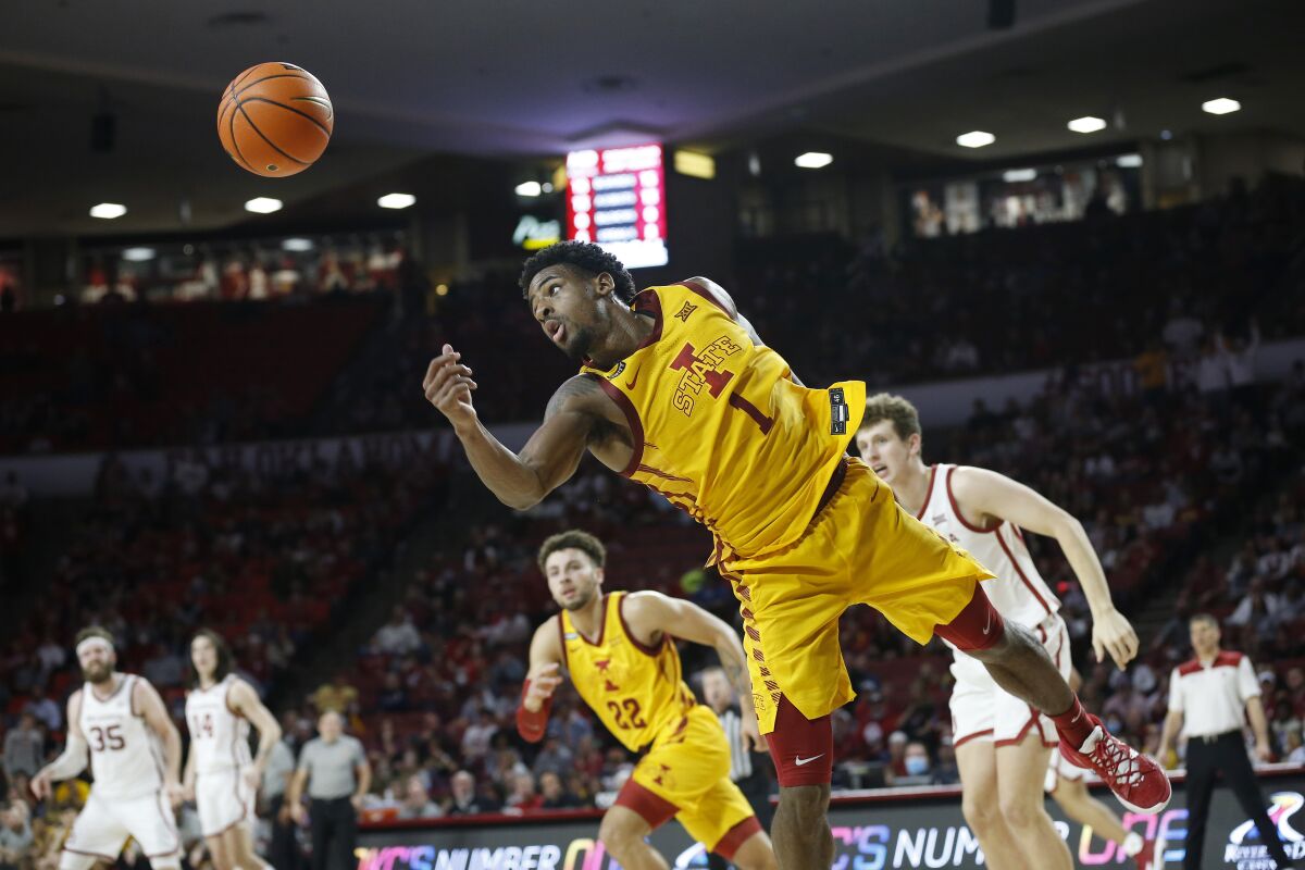 Iowa State guard Izaiah Brockington (1) lunges for a rebound during the second half of an NCAA college basketball game against Oklahoma, Saturday, Jan. 8, 2022, in Norman, Okla. (AP Photo/Garett Fisbeck)