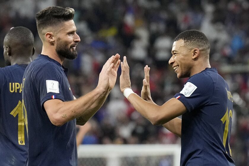 France's Olivier Giroud, left, and France's Kylian Mbappe celebrate after scoring their side's second goal.