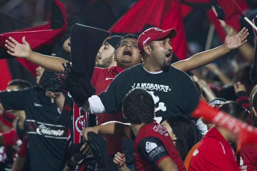 Fans of Tijuana's soccer team cheer for their team during a Mexican soccer league match with Toluca in Tijuana, Mexico, Thursday, Nov. 29, 2012. (AP Photo/Christian Palma)