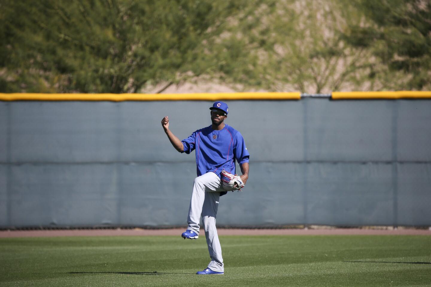Dexter Fowler waits to field fly balls during spring training at Sloan Park Friday, Feb. 26, 2016, in Mesa, Ariz.