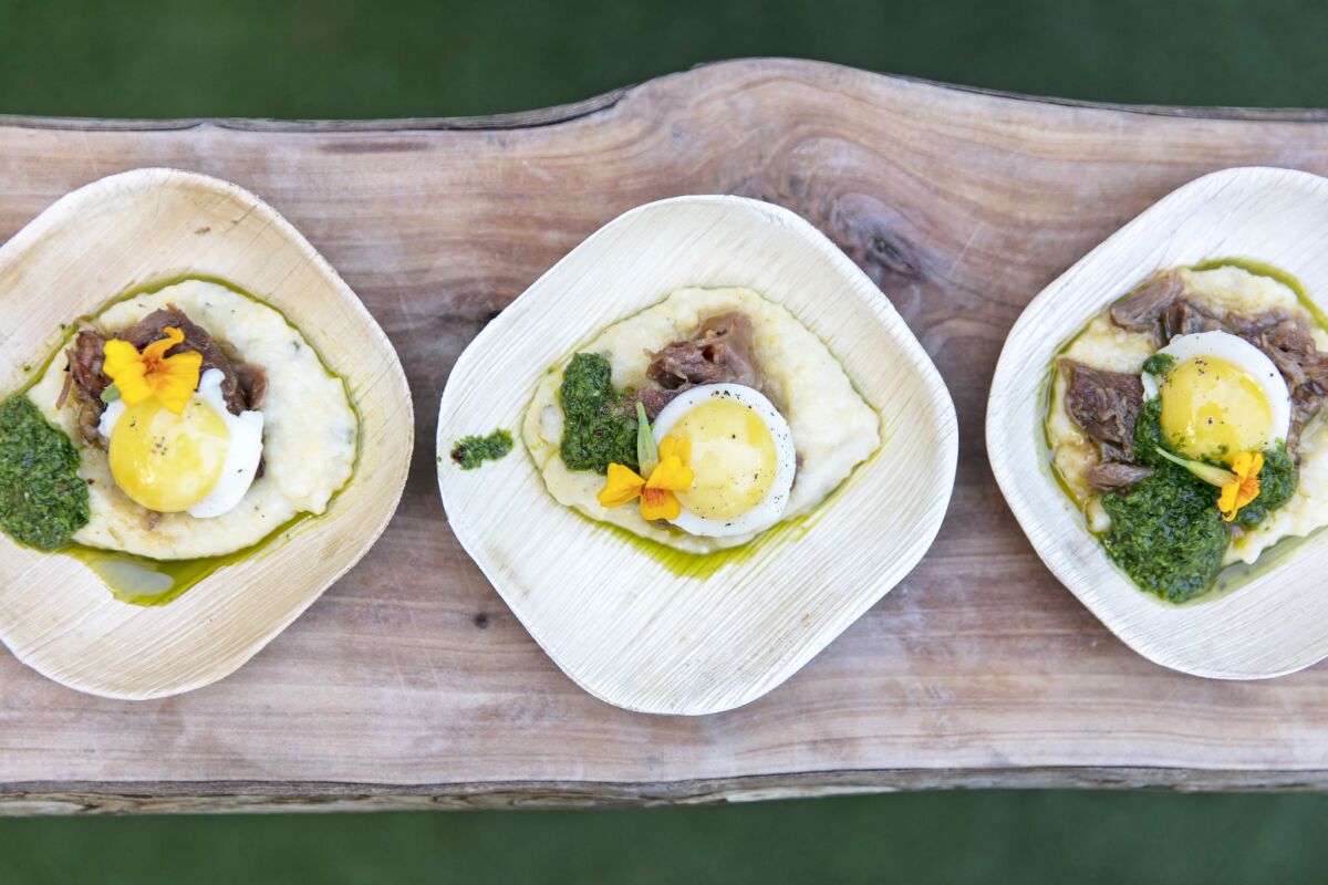 Rouge serves root-beer-braised pork cheek with white cheddar polenta, lemon gremolatta and quail egg during the last day of the L.A. Times' The Taste OC on Oct. 21.