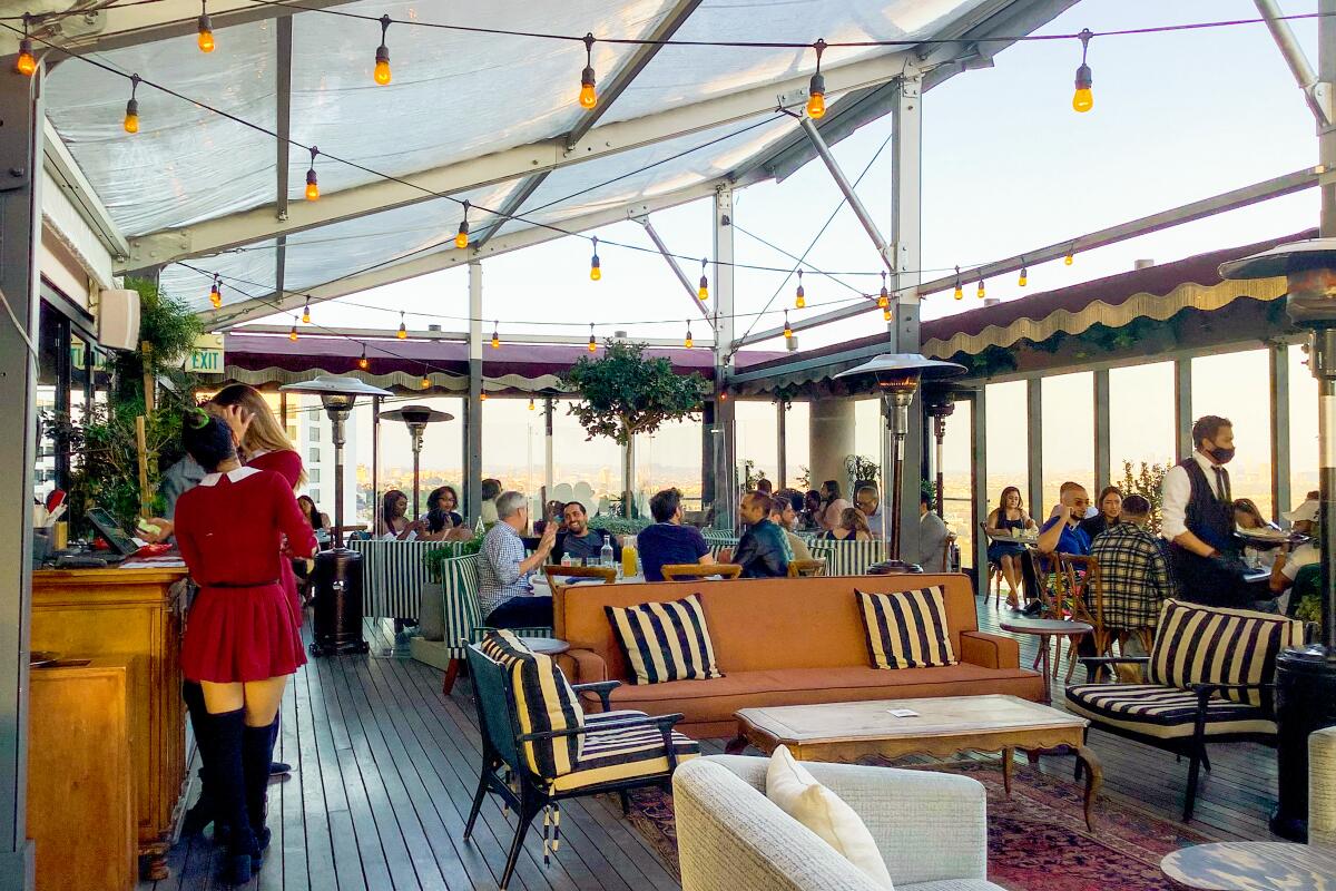 Patrons dine at Harriet's Rooftop on a busy evening.