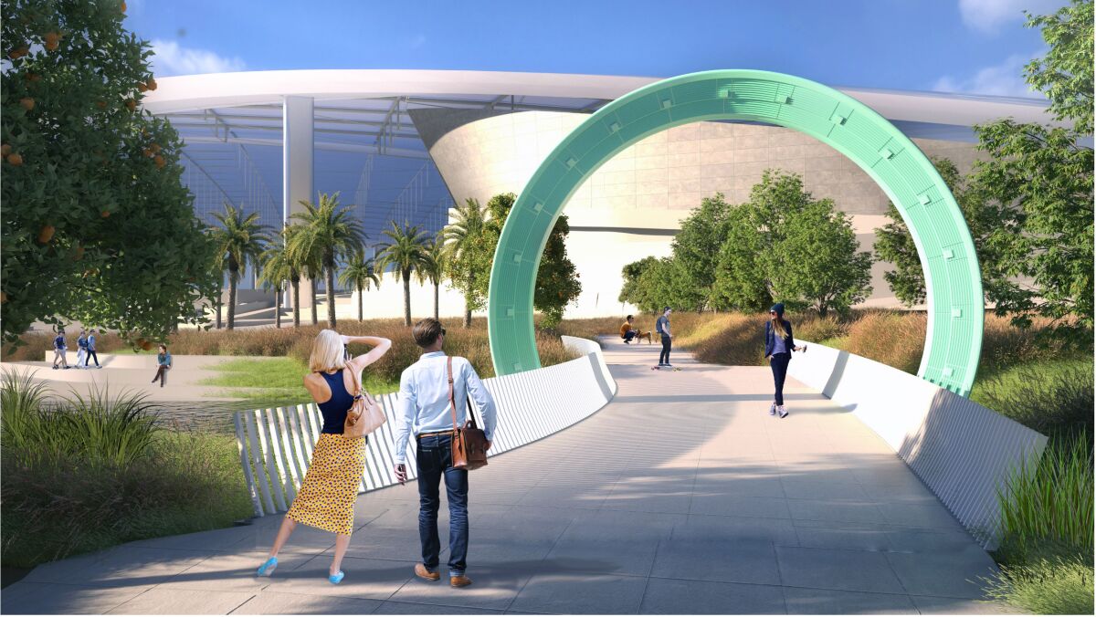 A rendering shows a circular architectonic structure in sea foam green on a pedestrian bridge before SoFi Stadium.