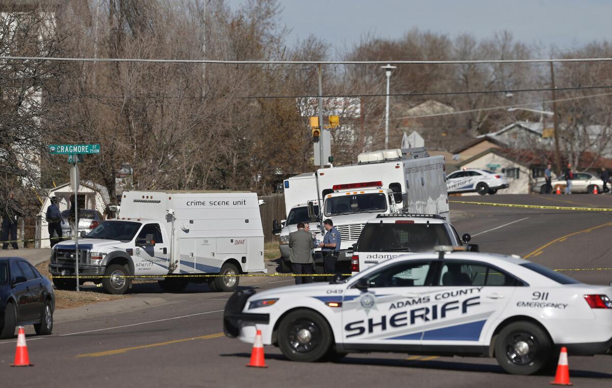 Authorities investigate the slayings of three people whose bodies were found inside a home, in the Denver suburb of Westminster, Colo.