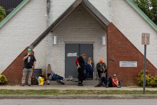 Huntington, WV - September 26: People who are unhoused hang outside the Huntington City Mission's chapel on Tuesday, Sept. 26, 2023 in Huntington, WV. (Jason Armond / Los Angeles Times)