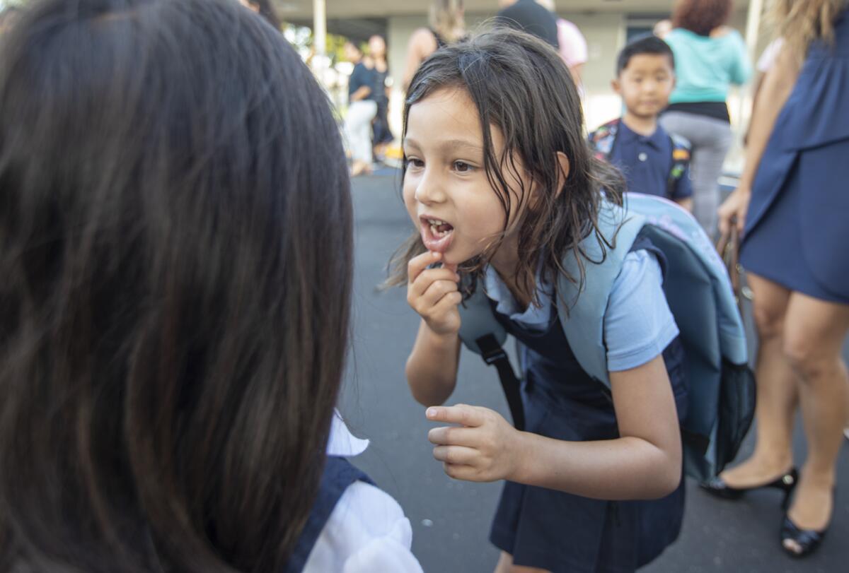 A student and her friend during the first day of school at the International School for Science and Culture in Costa Mesa.