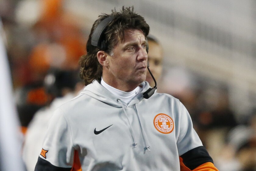In this Nov. 30, 2019 file photo Oklahoma State head coach Mike Gundy walks on the sidelines.