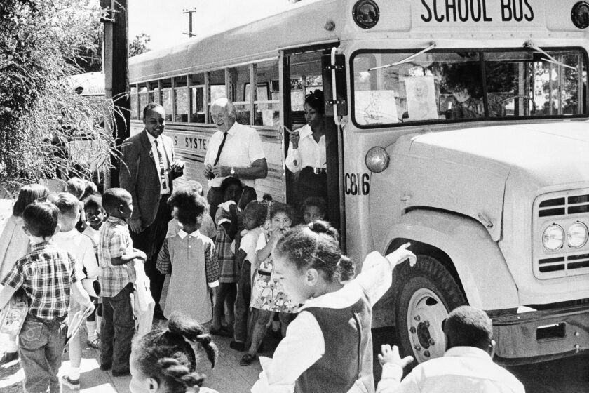 Youngsters head for a school bus in Berkeley, California on Feb. 24, 1970, where a busing program tomix black and white youngsters has been working for 18 months with apparent decline in opposition in this hometown of Black Panther leaders Bobb Seale and Huey P. Newton. Superintendent of schools, Dr. Richard L. Foster says a survey before busing indicated a 50 per cent opposition to the program, but most recent estimates are only 30 per cent. (AP Photo/RWK)