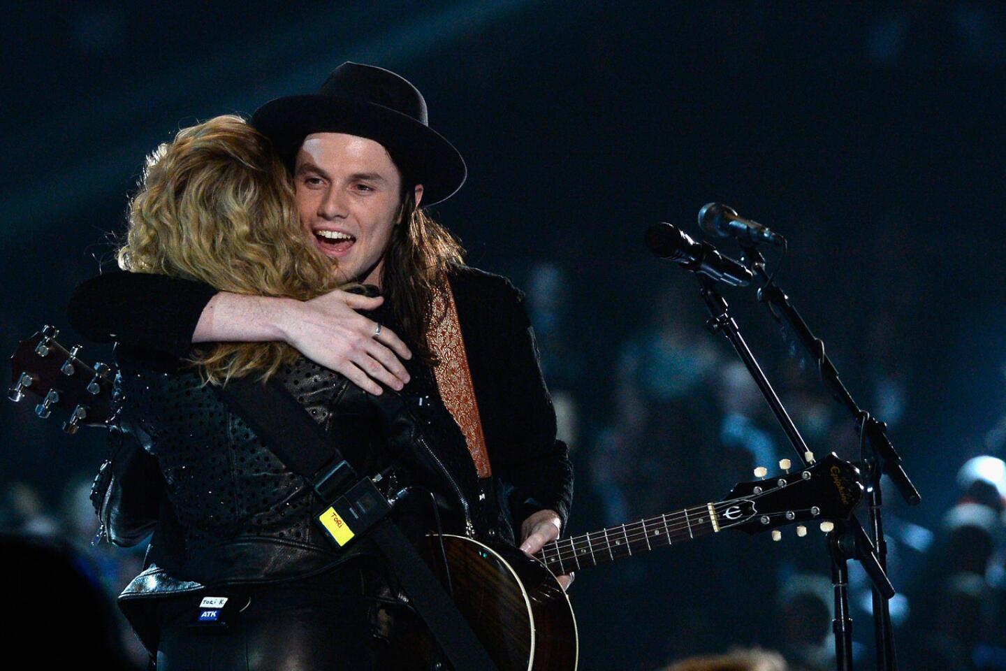 Tori Kelly, left, and James Bay embrace after perfoming a rendition of their songs "Hollow" and "Let It Go."